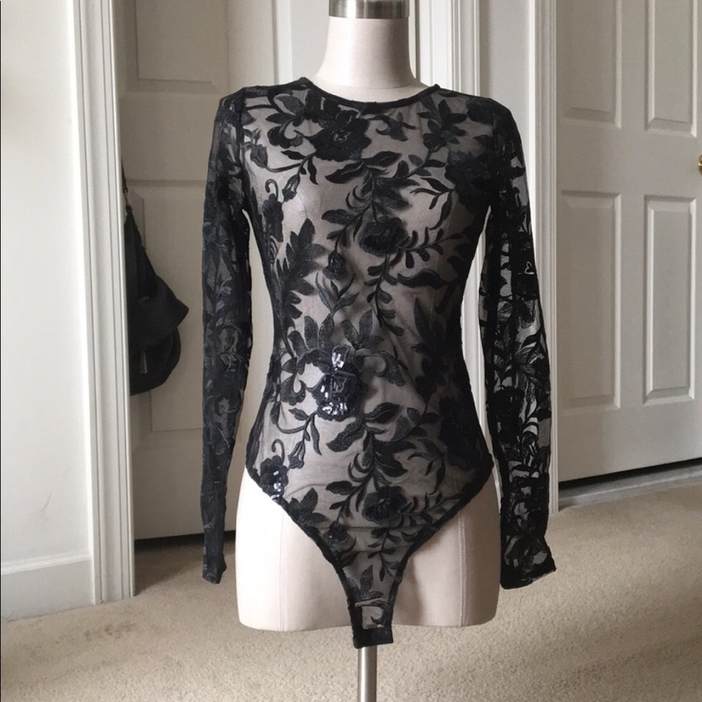 NWT.  Never worn sheet lace body suit Medium
